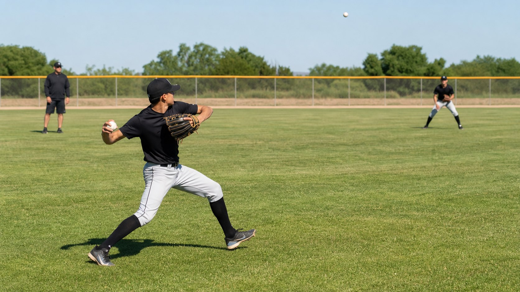Outfielder tracking a fly ball before making a throw during baseball practice