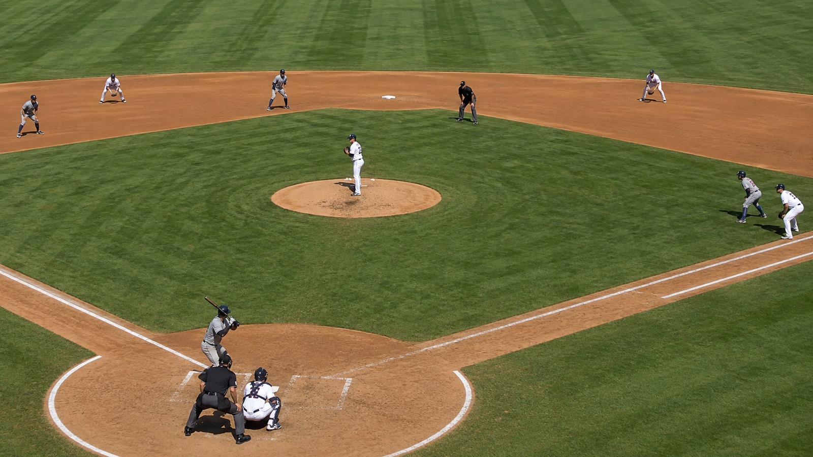 Baseball field set with runners on every base and the defense ready before a bases-loaded pitch